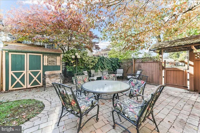 a view of a backyard with a patio and outdoor seating