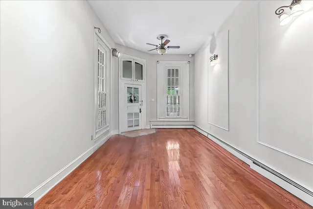 wooden floor in an empty room with a window