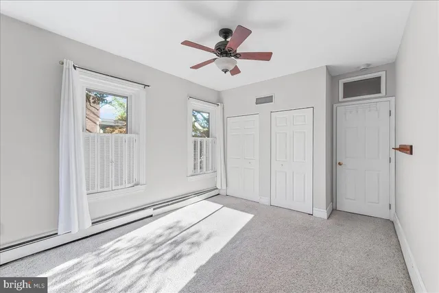 a view of roof deck with wooden fence and floor