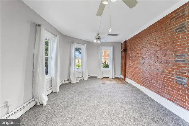 a view of an empty room with a fireplace