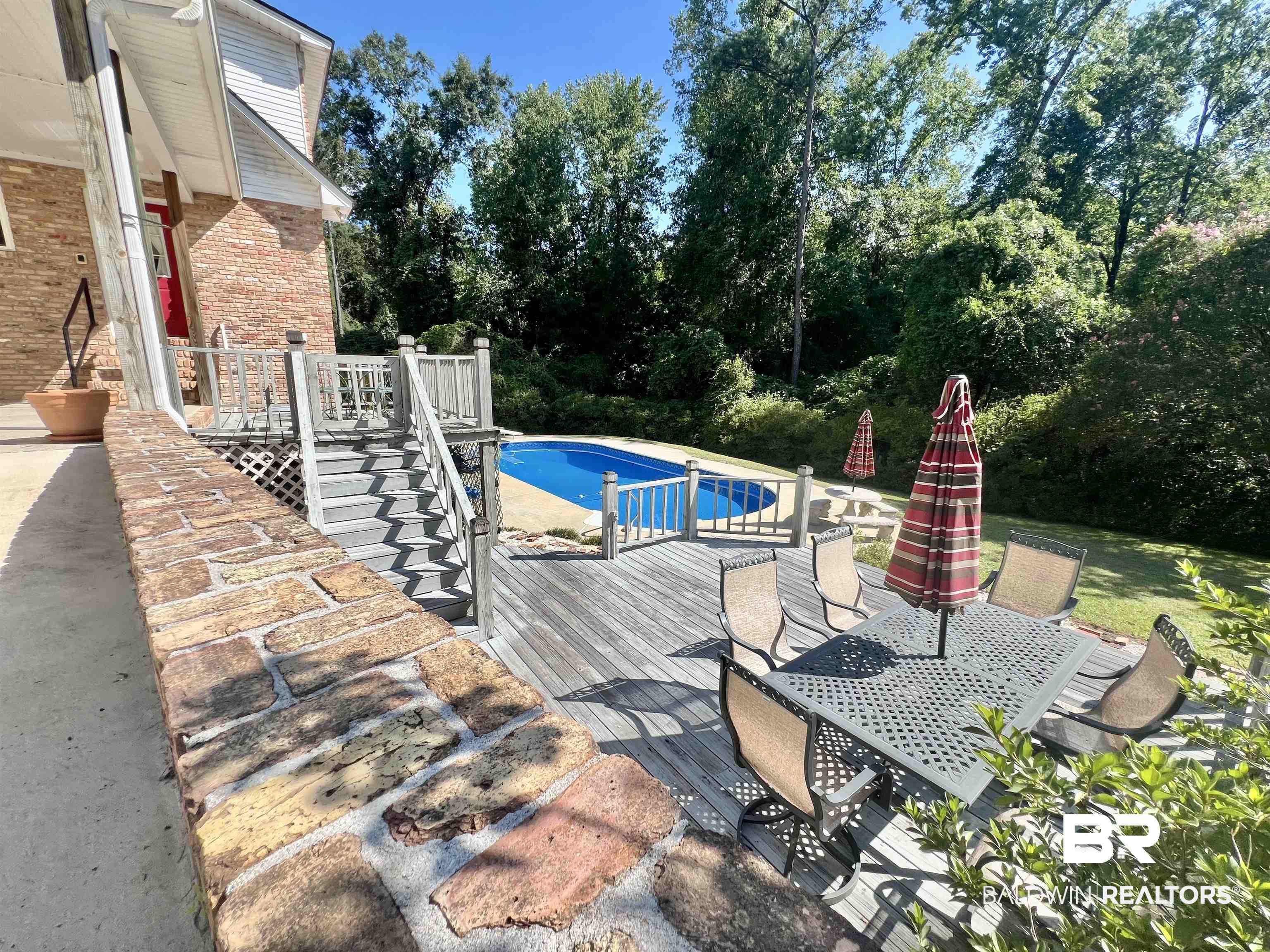 2691 Appleton Road Brewton, AL 36426 - Photo 48 of 60 Outdoor pool featuring a wooden deck, view of wooded area, and outdoor dining space