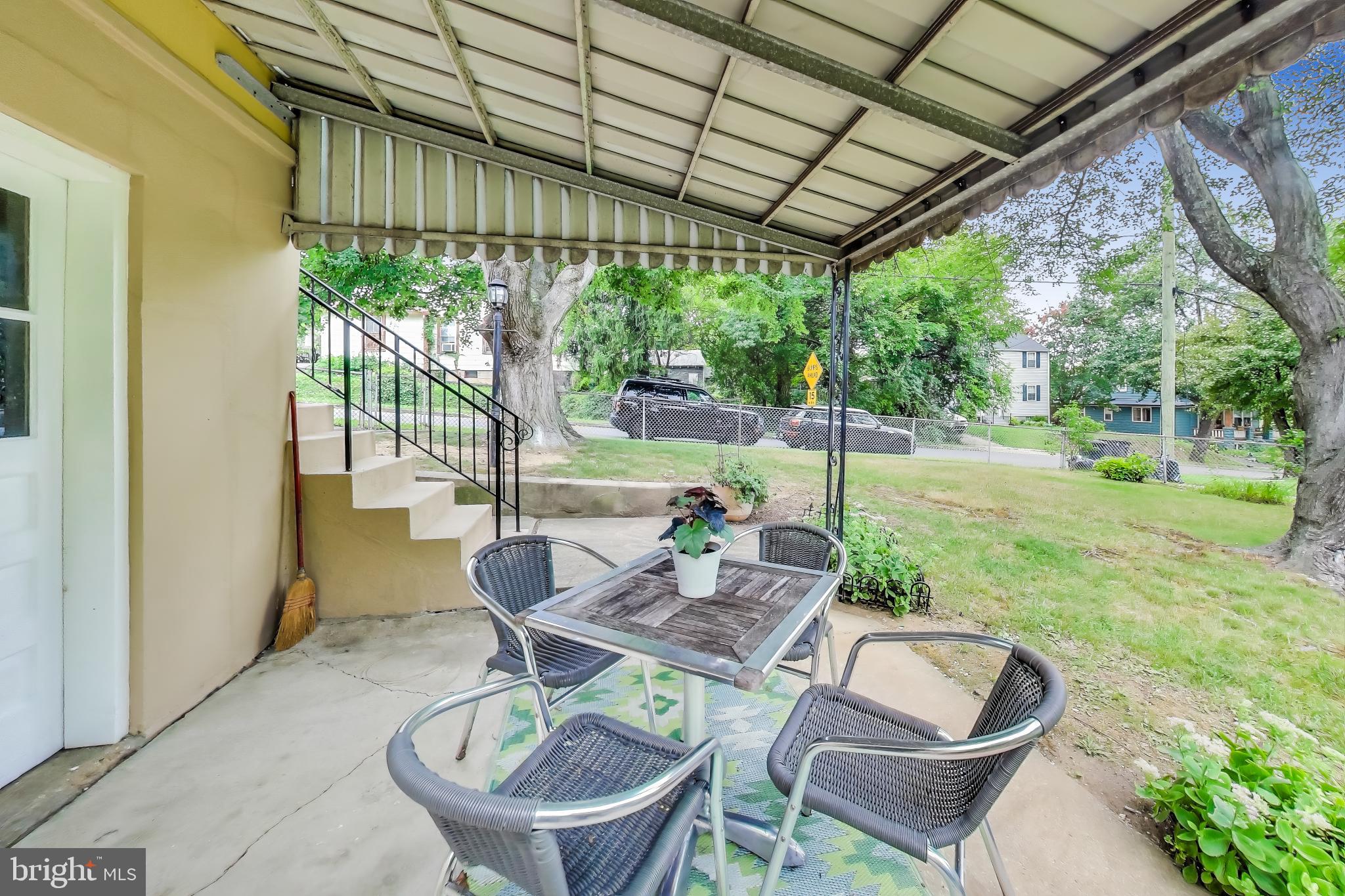 4401 32nd Street Mount Rainier, MD 20712 - Photo 27 of 38 a view of a patio with a table chairs and a backyard