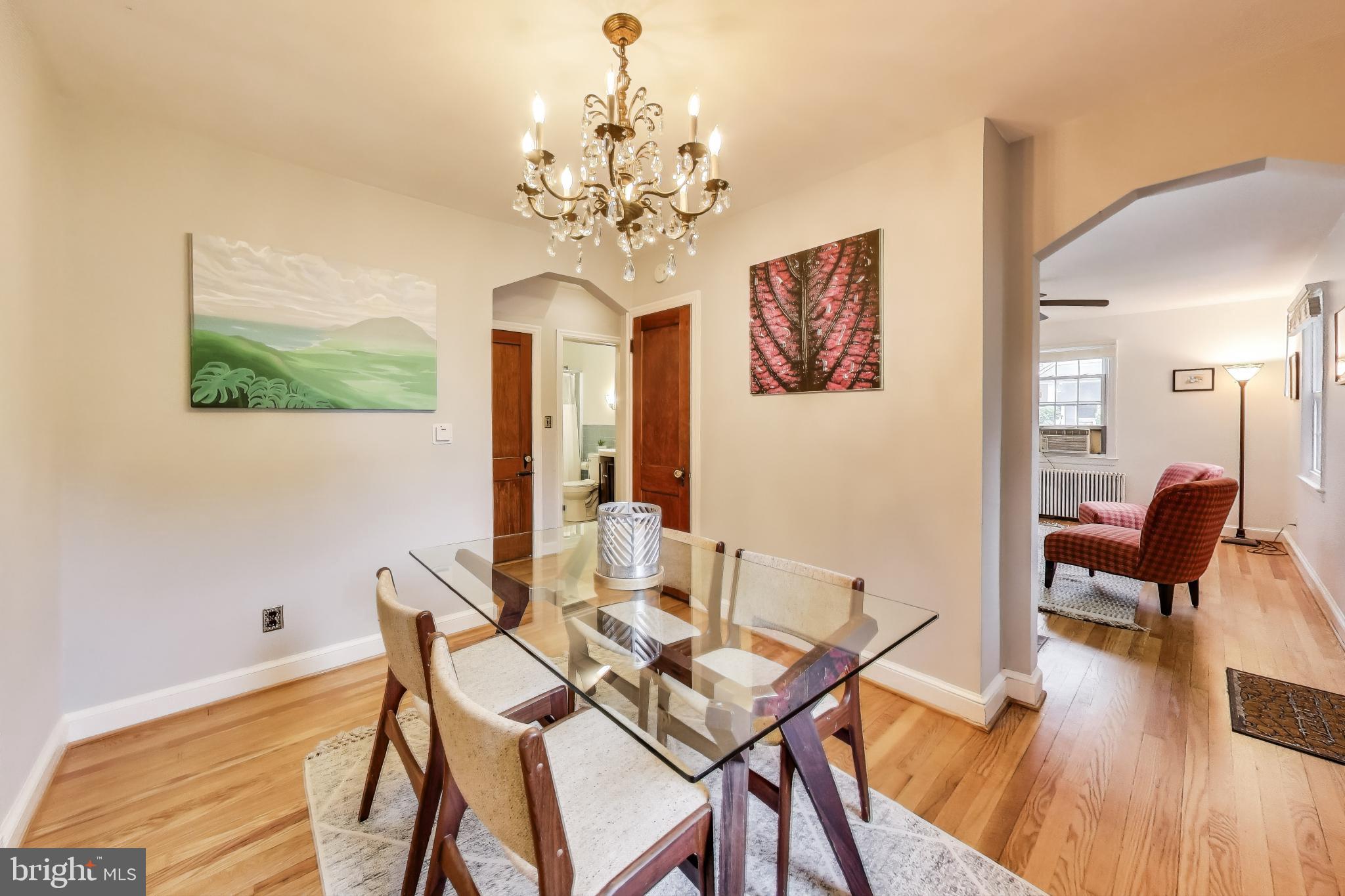 4401 32nd Street Mount Rainier, MD 20712 - Photo 3 of 38 a view of a dining room with furniture wooden floor and a chandelier
