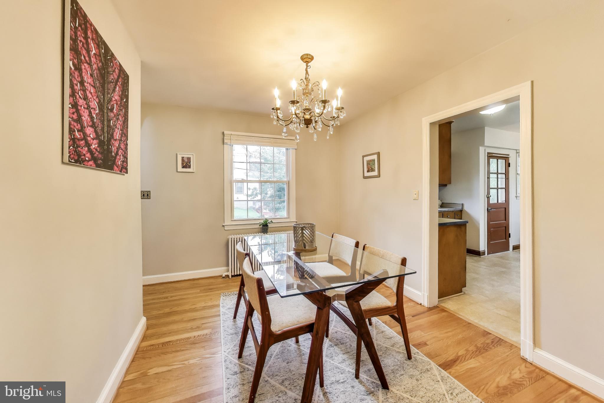 4401 32nd Street Mount Rainier, MD 20712 - Photo 7 of 38 a view of a dining room with furniture and a chandelier