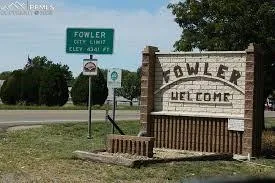 a view of a park with iron fence