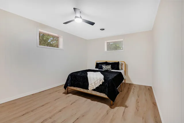 a bedroom with bed and a window