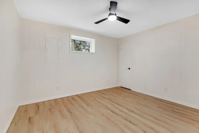 a view of an empty room with a fan