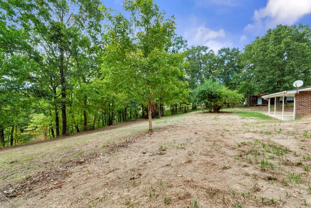 a backyard of a house with barbeque oven and outdoor seating