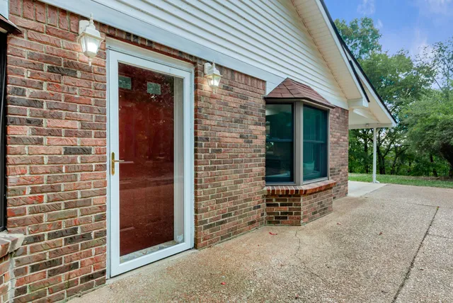 a view of front door of house with stairs