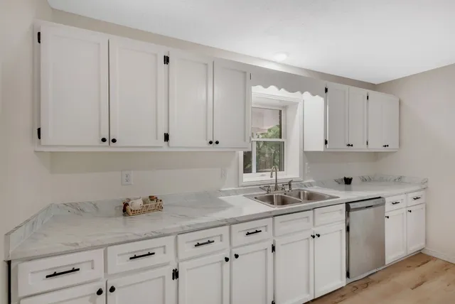 a kitchen with white cabinets
