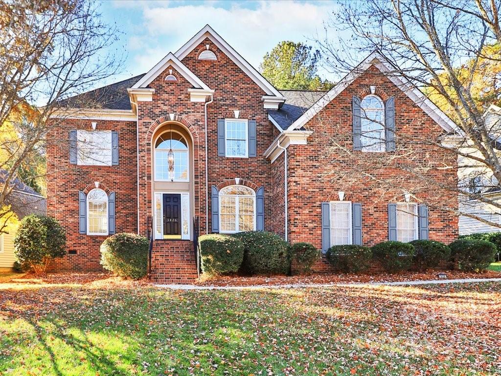 3426 Rhett Butler Place Charlotte, NC 28270 - Photo 1 of 40 a front view of a house with a yard and garage