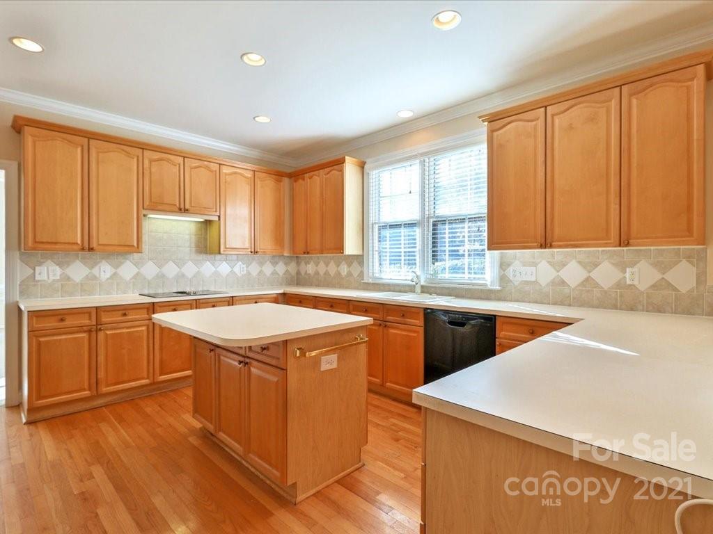 3426 Rhett Butler Place Charlotte, NC 28270 - Photo 11 of 40 a kitchen with stainless steel appliances granite countertop cabinets sink and wooden floor
