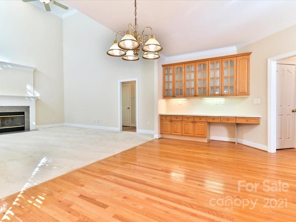 3426 Rhett Butler Place Charlotte, NC 28270 - Photo 15 of 40 a view of an empty room with a chandelier fan and kitchen view