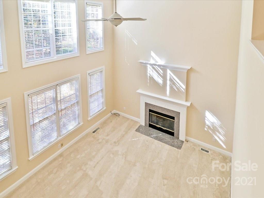 3426 Rhett Butler Place Charlotte, NC 28270 - Photo 23 of 40 a view of an empty room with a fireplace and a window