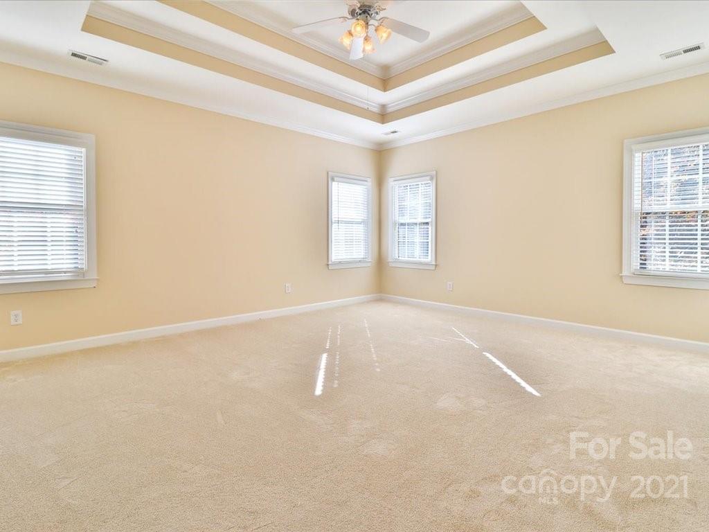 3426 Rhett Butler Place Charlotte, NC 28270 - Photo 25 of 40 an empty room with windows and ceiling fan
