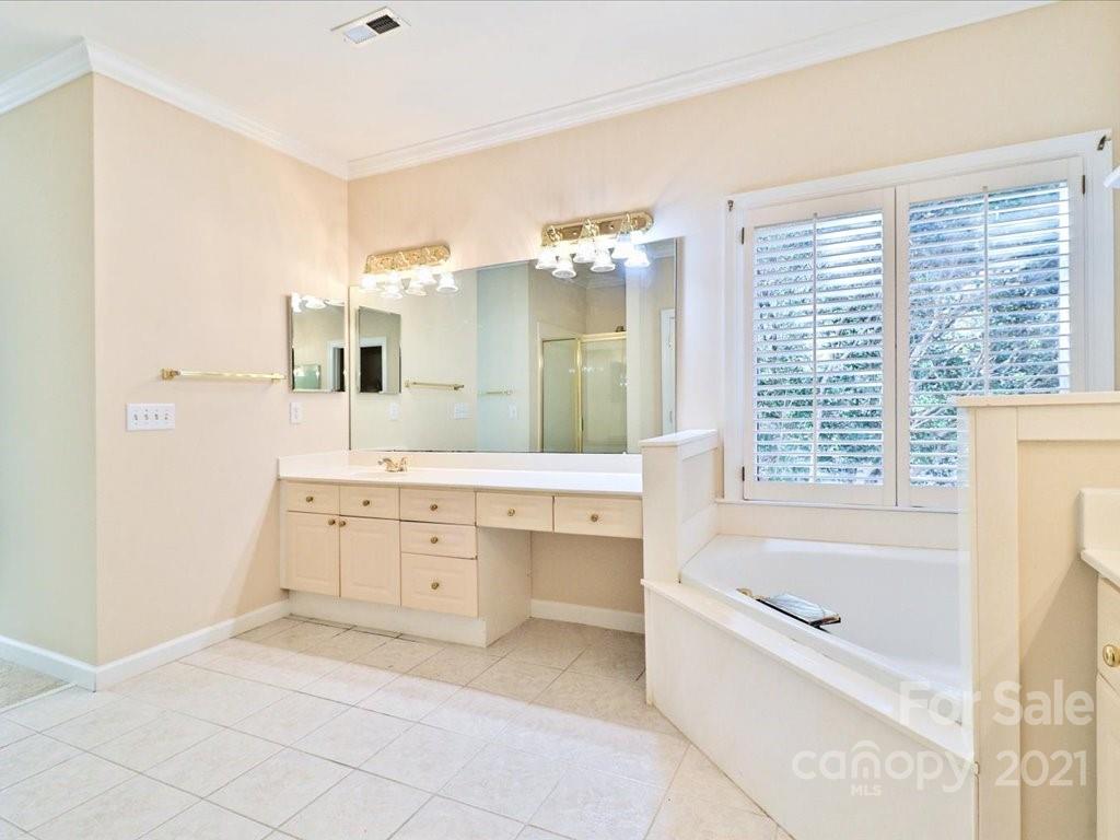 3426 Rhett Butler Place Charlotte, NC 28270 - Photo 28 of 40 a spacious bathroom with a tub sink shower and mirror