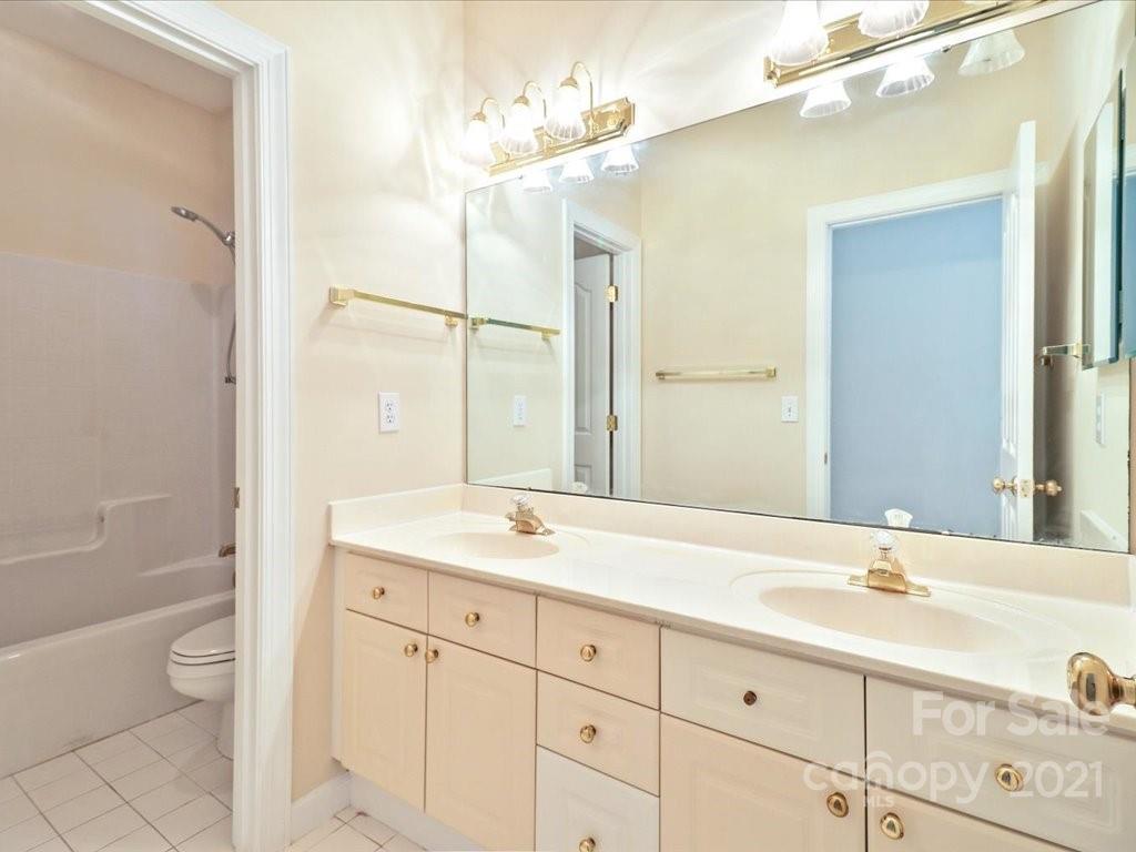 3426 Rhett Butler Place Charlotte, NC 28270 - Photo 32 of 40 a bathroom with a sink a toilet and a large mirror