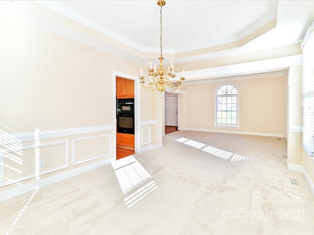 3426 Rhett Butler Place Charlotte, NC 28270 - Photo 6 of 40 a view of a room with window and chandelier