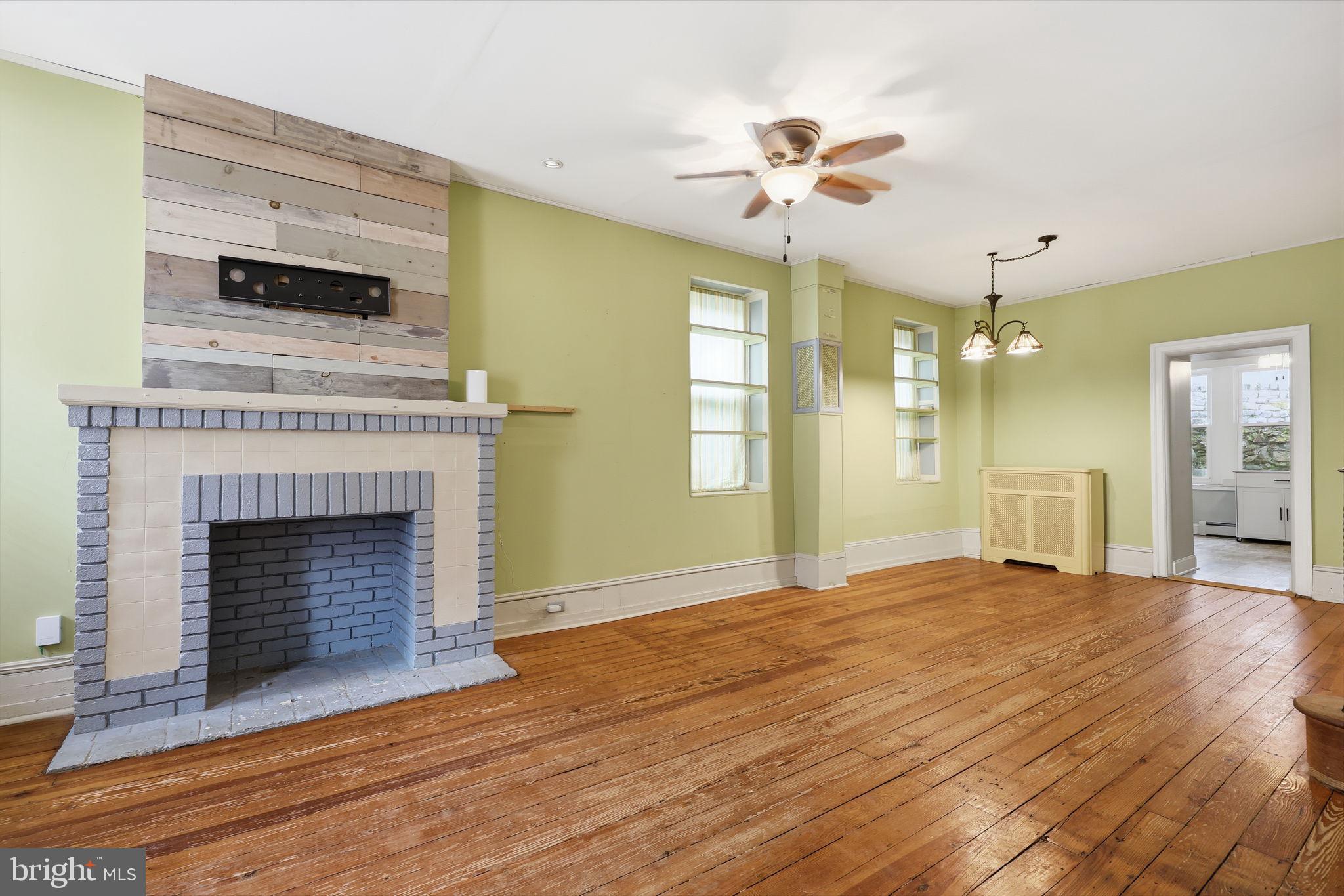 353 Hermitage Street Philadelphia, PA 19128 - Photo 4 of 31 a view of an empty room with a fireplace and window