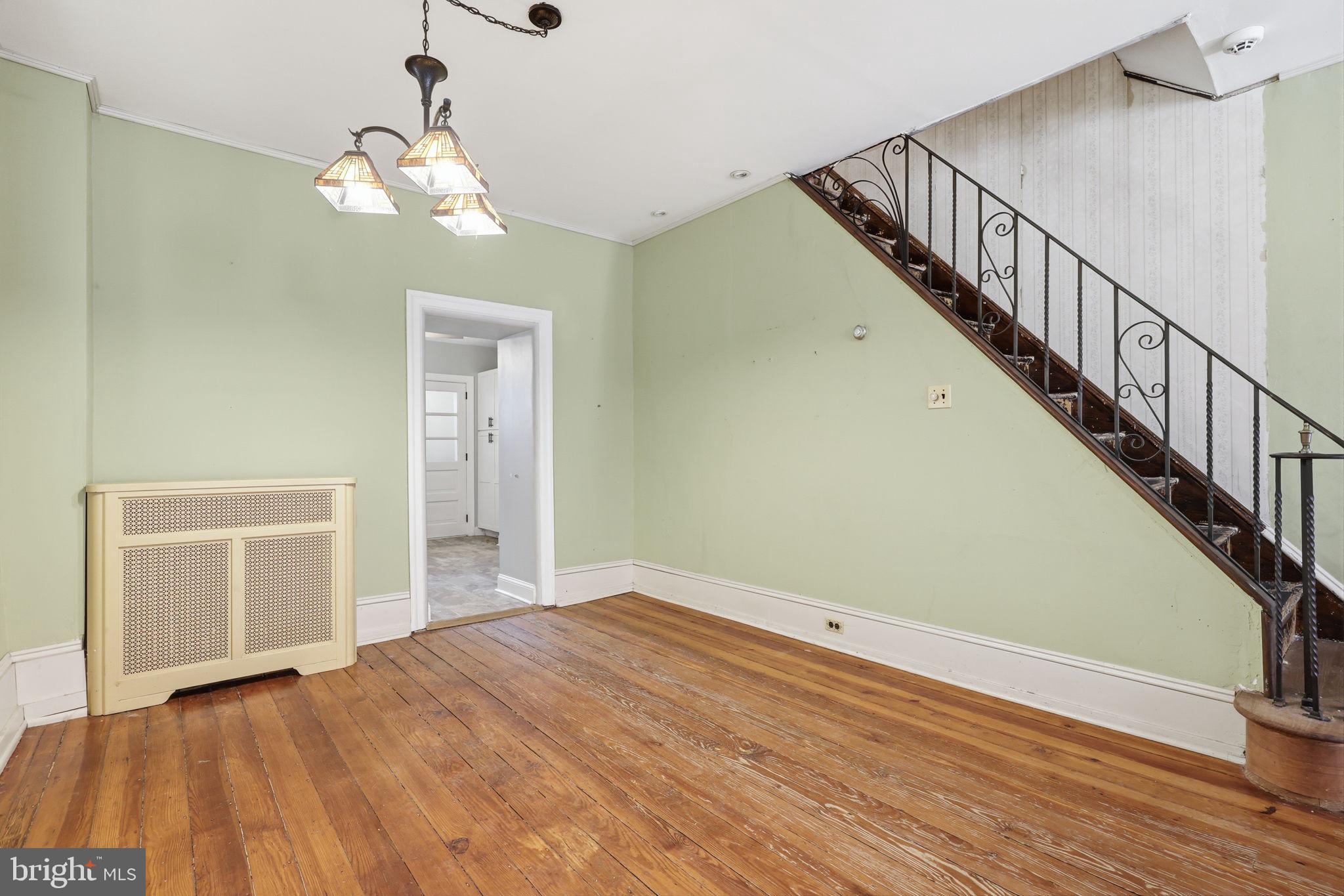 353 Hermitage Street Philadelphia, PA 19128 - Photo 7 of 31 a view of a livingroom with wooden floor and stairs