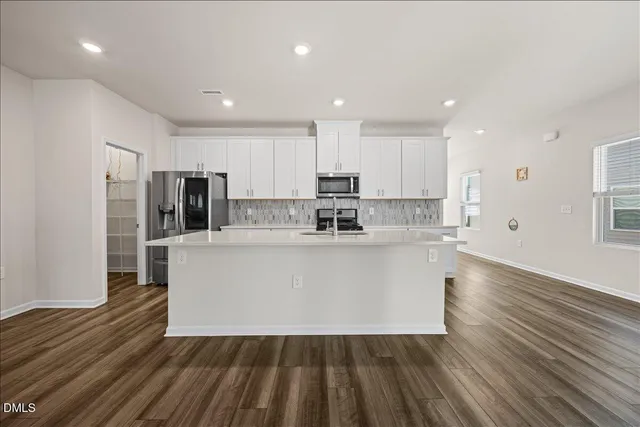 a white cabinets and wooden floor