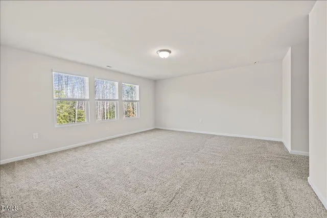 a spacious bathroom with a shower a sink and a mirror