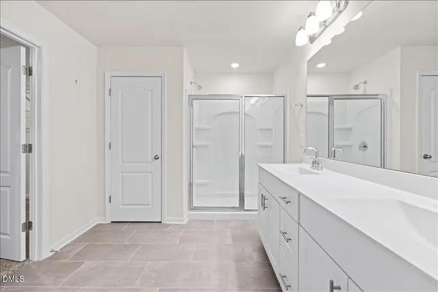 a bathroom with a sink a mirror and a shower