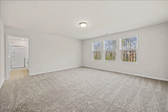 a bathroom with a toilet a sink a mirror and vanity