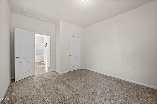 an empty room with closet area