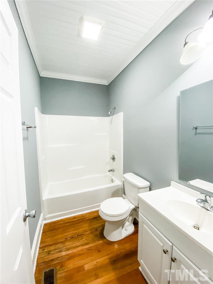 910 Gilbert Street Durham, NC 27701 - Photo 11 of 24 a bathroom with a sink a toilet and shower