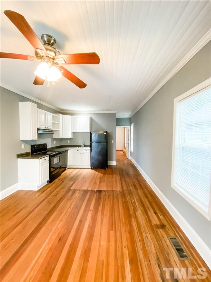910 Gilbert Street Durham, NC 27701 - Photo 9 of 24 a view of a kitchen with a sink and wooden floor