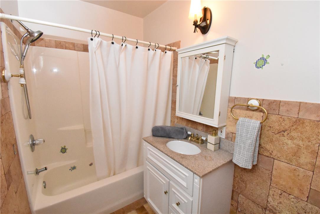 424 Grape Street Whitehall, PA 18052 - Photo 37 of 50 This bathroom features a shower and vanity with a well-lit mirror, offering both comfort and practicality.