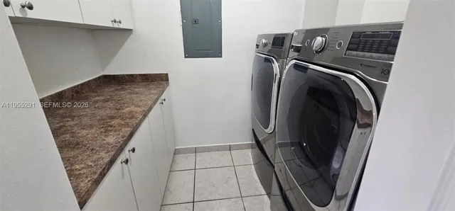 a view of storage and utility room with washer and dryer