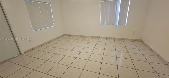 a view of an empty room and utility room
