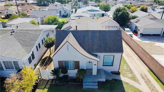 an aerial view of a house with table and chairs
