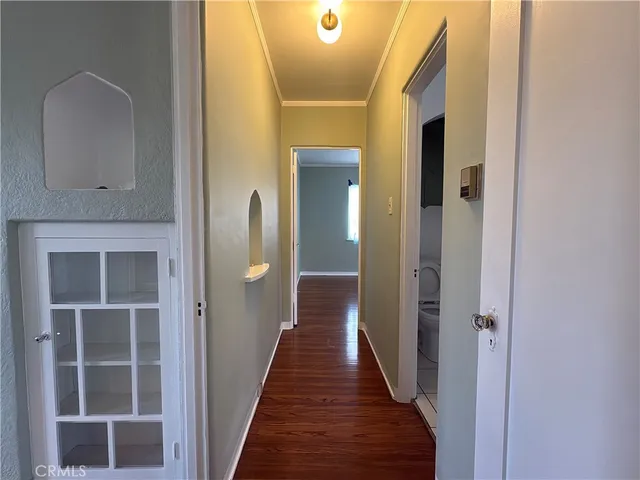 a view of a hallway with wooden floor and entryway