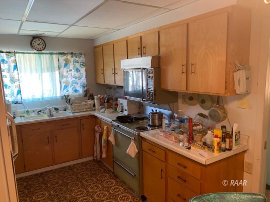 1302 South Mahan Street Ridgecrest, CA 93555 - Photo 4 of 17 a kitchen with a sink cabinets and window