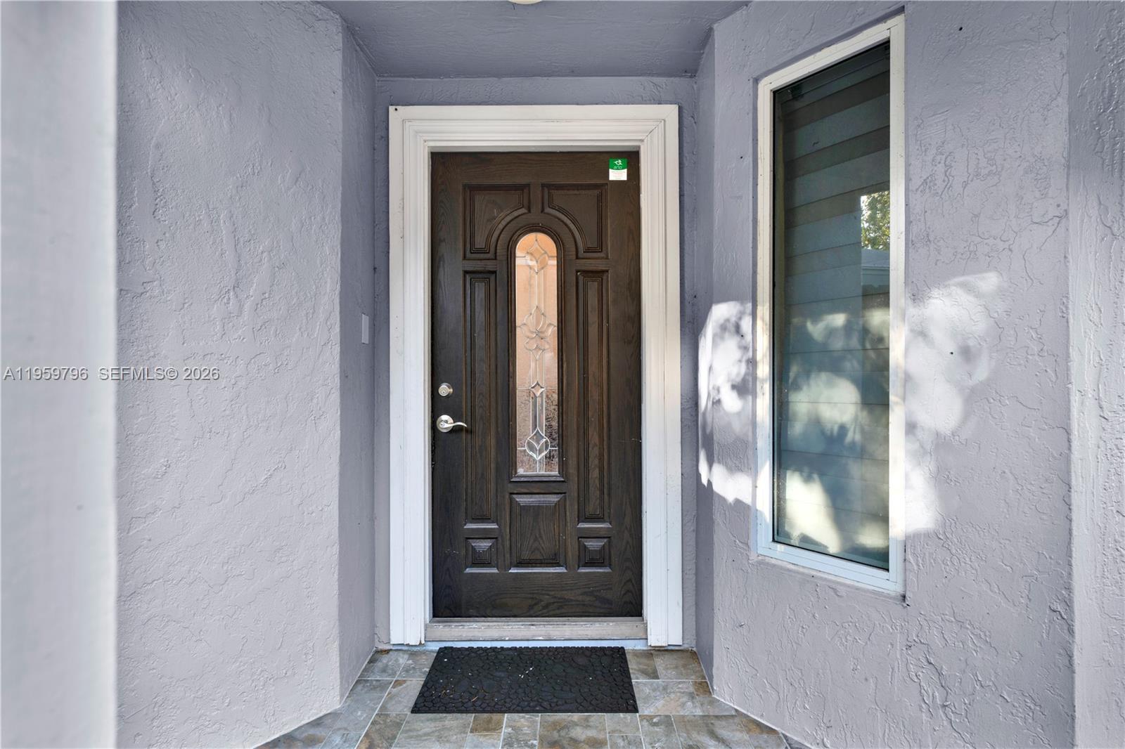 14600 Southwest 124th Place Miami, FL 33186 - Photo 2 of 34 a view of a glass door with a glass door and a window