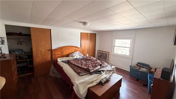 a bedroom with furniture and a window