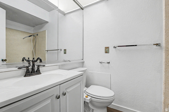 34 Benchmark Village Tooele, UT 84074 - Photo 20 of 35 Full bath with vanity, a textured wall, and a shower