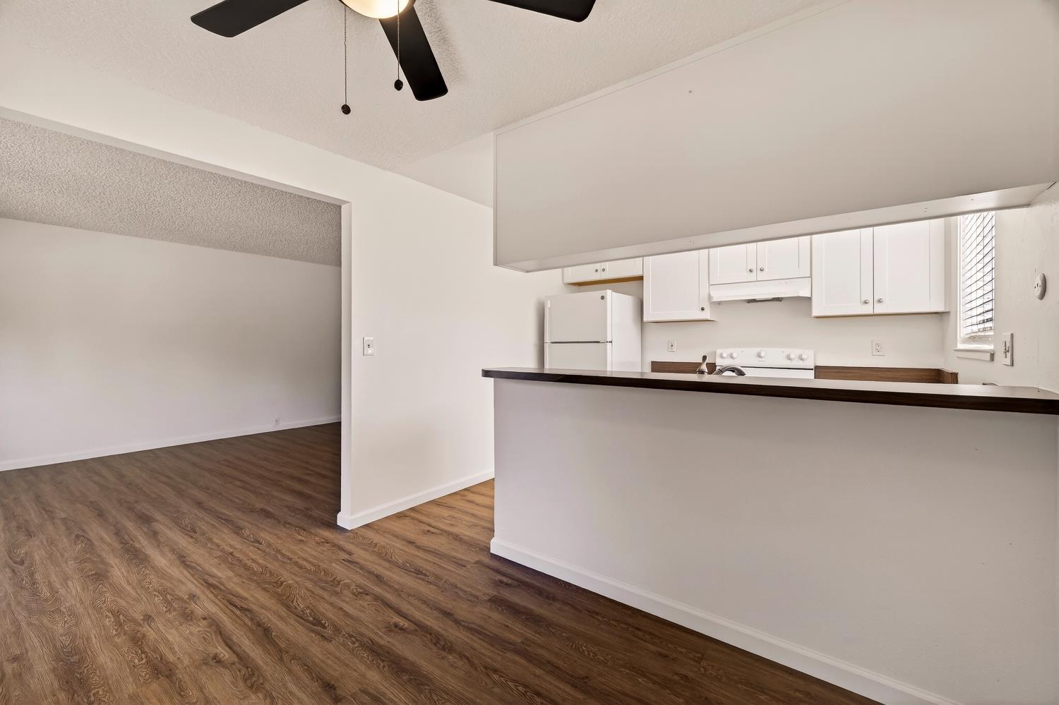 615 Rancheria Drive Chico, CA 95926 - Photo 13 of 80 a kitchen with granite countertop a sink and a wooden floor