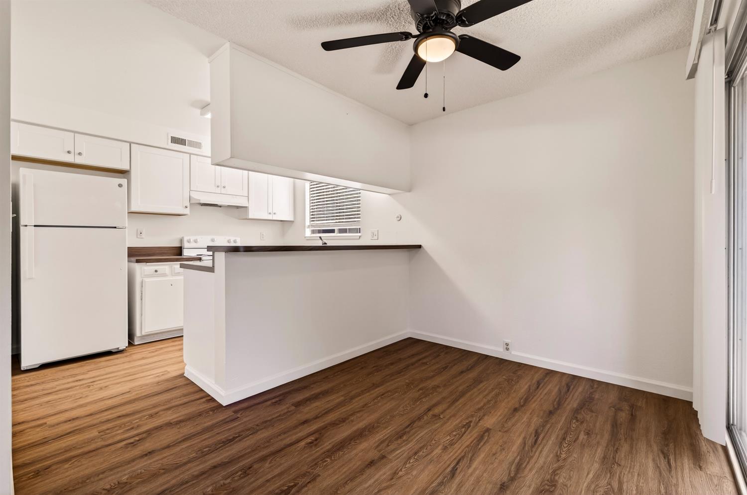 615 Rancheria Drive Chico, CA 95926 - Photo 15 of 80 a view of a kitchen with wooden floor and a ceiling fan