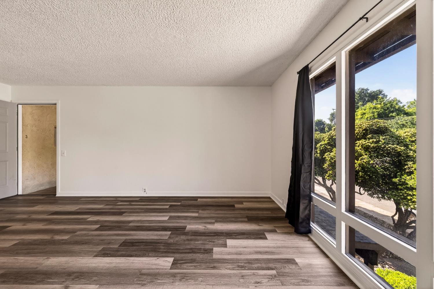 615 Rancheria Drive Chico, CA 95926 - Photo 30 of 80 a view of an empty room with wooden floor and a window