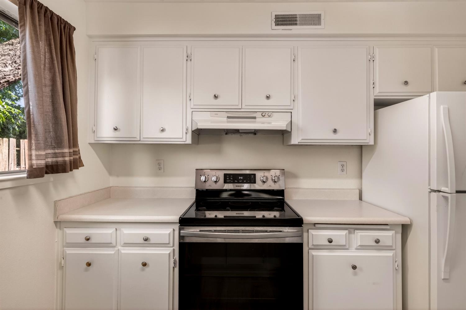 615 Rancheria Drive Chico, CA 95926 - Photo 54 of 80 a kitchen with granite countertop white cabinets and white appliances