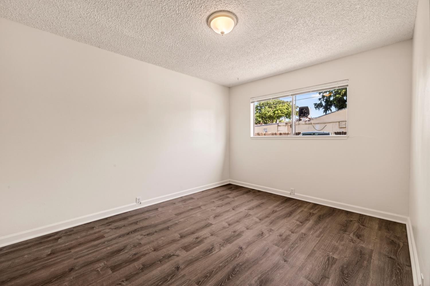 615 Rancheria Drive Chico, CA 95926 - Photo 58 of 80 an empty room with wooden floor and window