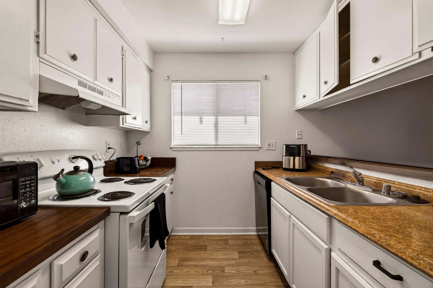 615 Rancheria Drive Chico, CA 95926 - Photo 68 of 80 a kitchen with stainless steel appliances granite countertop a sink stove top oven and cabinets