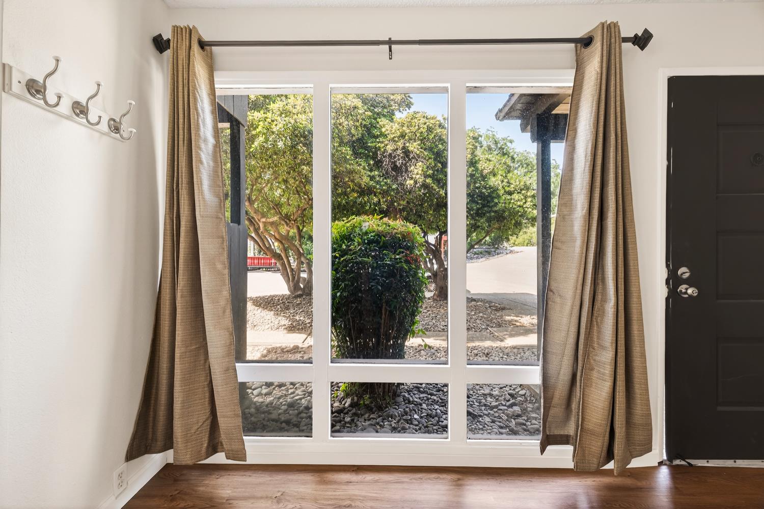 615 Rancheria Drive Chico, CA 95926 - Photo 10 of 80 a view of a living room with a large window and wooden floor