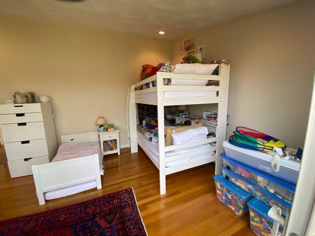 14 Park Place, Unit 14 Arlington, MA 02474 - Photo 14 of 20 a bedroom with furniture and a wooden floor