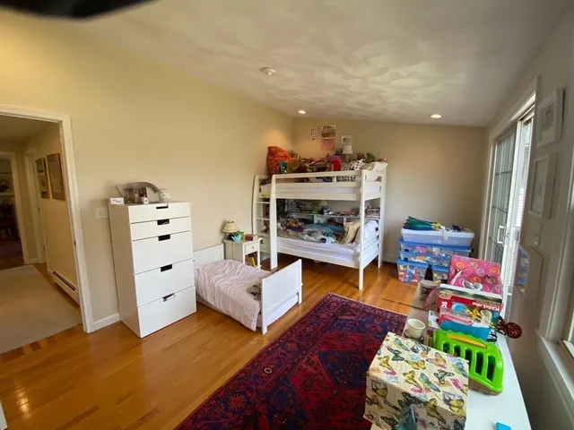 a living room with furniture and a baby crib