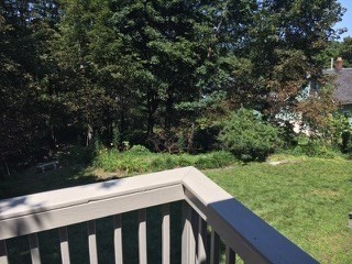 14 Park Place, Unit 14 Arlington, MA 02474 - Photo 19 of 20 a balcony with wooden floor and yard in the back